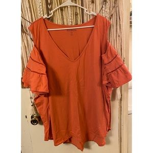 Tangerine colored, cold shoulder flowey arm shirt